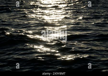 Sun reflecting in water surface Stock Photo