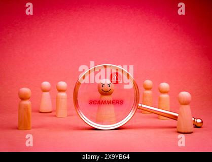 Hacker criminal, cyberattack, cybercrime, data system hacking and fraud and security attack concepts. Scammer, text and wooden figure with warning ico Stock Photo