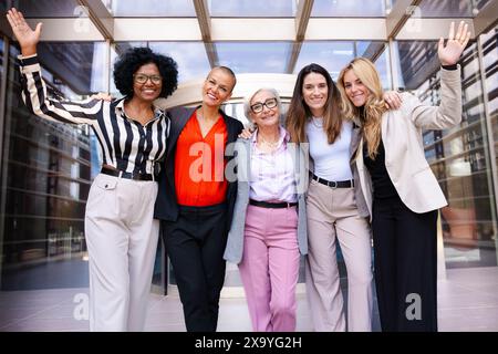 Multiracial businesswomen led by boss posing happy for the camera. Stock Photo