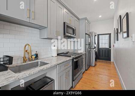 A modern empty kitchen available for rent and ready for use. Stock Photo
