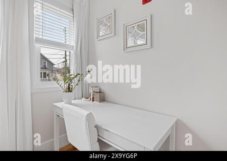 A desk in corner with wall art Stock Photo