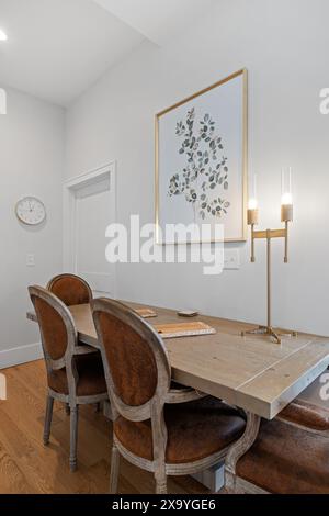 A table and chairs with one chair on each side of the table Stock Photo