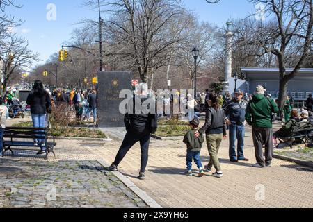 A large group of individuals gathered around the Prospect Park War Memorial in Brooklyn, New York Stock Photo