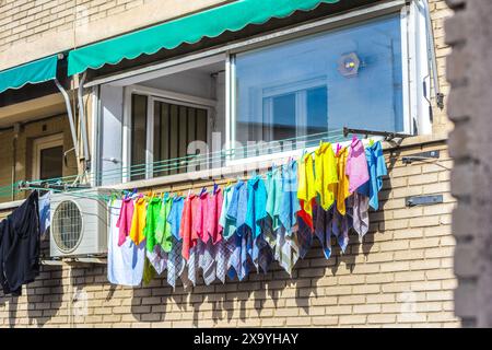 Kitchen towels from a chef or restaurant hanging on a clothesline, drying in the sun. Stock Photo