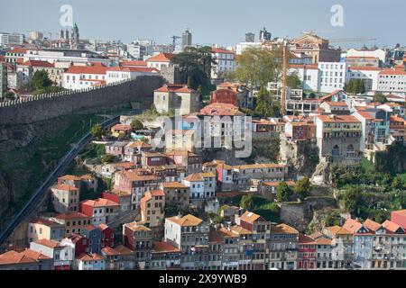 Porto,Portugal,Douro river and local houses with orange roofs in Porto city aerial panoramic view. Porto is the second largest city in Portugal. Stock Photo