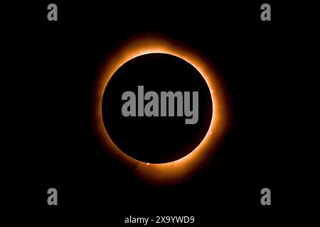 A solar eclipse featuring a diamond ring effect and baileys beads Stock Photo