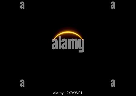 A solar eclipse featuring a diamond ring effect and baileys beads Stock Photo