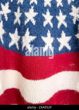Close-up photo of a USA Flag patriotic knitted wool red blue white sweater with stripes and stars in traditional icelandic pattern Stock Photo