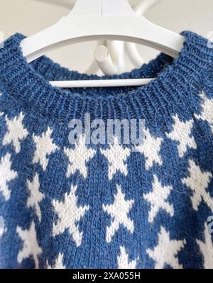 Close-up photo of a USA Flag patriotic knitted wool sweater yoke with white stars on blue background and ribbed neckband Stock Photo