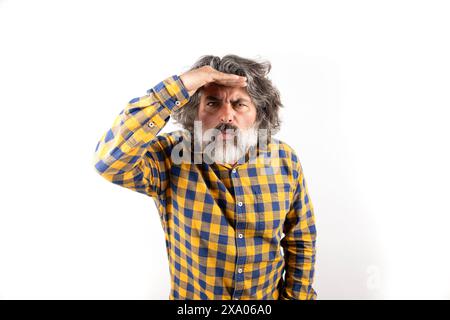 A middle-aged man with concerned look gazing into the distance in search of something Stock Photo