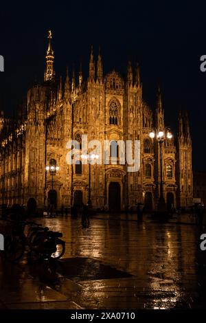 A night view of the grand Milan cathedral with multiple spires Stock Photo