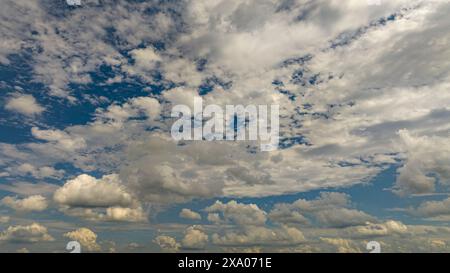 The bright blue sky with fluffy white clouds Stock Photo