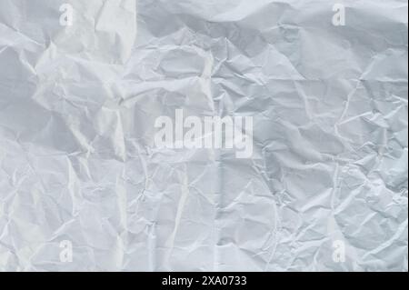 Flat crumpled white paper background with abstract crease lines Stock Photo