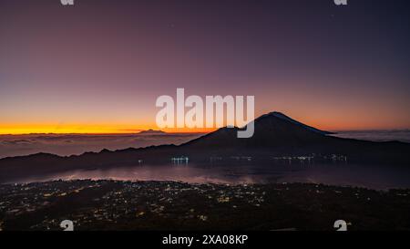 Vibrant sunset sky over mountains, glowing with warm colors Stock Photo