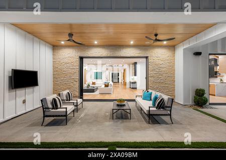 Interior with white chairs, tables, and a couch Stock Photo