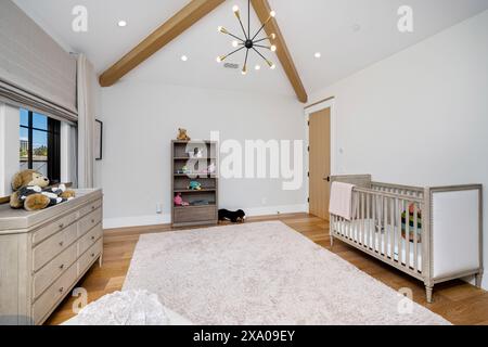 Baby's room with wooden beams and white walls Stock Photo