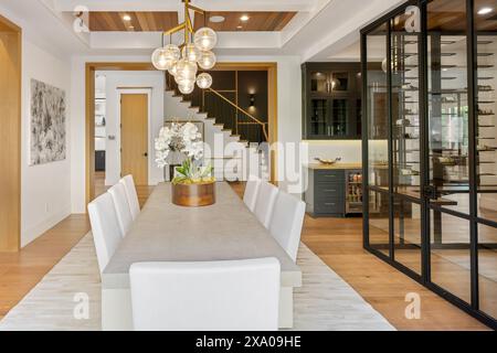 A dining area with chairs next to a spiral staircase Stock Photo