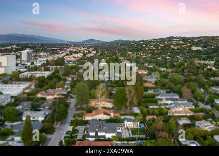 Aerial view of the cityscape with lush green hills, a serene lake in ...