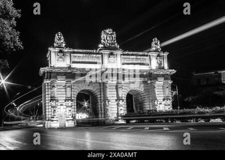 Bombs Gate of Floriana, Malta by Night with car lights trails in black and white Stock Photo