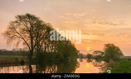 A sunset reflections on waterway's surface Stock Photo