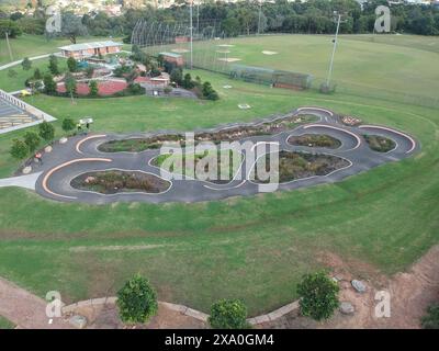 An aerial view of a race track with a football field in the background Stock Photo