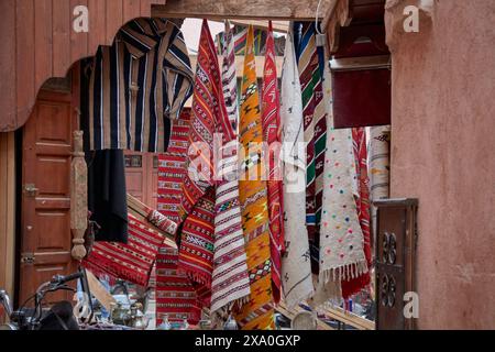 A street store in the city of Marrakech in Morocco where we see colorful blankets made on artisan looms using wool and cotton Stock Photo