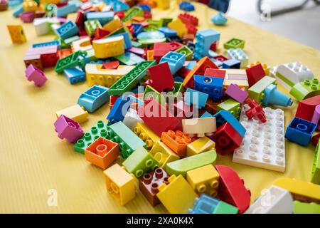 Unorgainized pile of kids building blocks of various shapes and sizes are ready to be stacked. Stock Photo