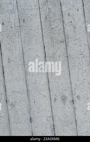 A pale gray concrete wall with small cracks Stock Photo