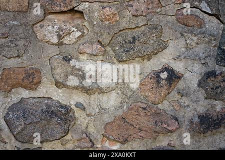An antique stone wall background from a gray stone. Stock Photo