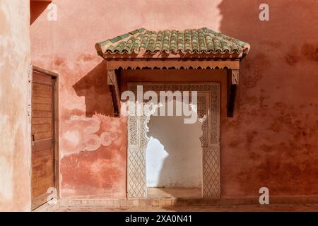 A Moroccan archway with green tiled roof featuring scalloped edges. Stock Photo