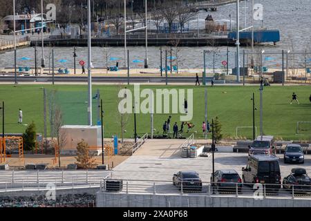 A group of people playing on a soccer field Stock Photo