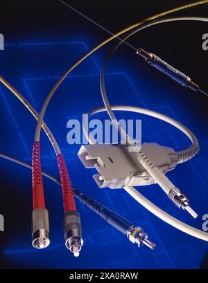 Fiber optic and data cables with connectors on blue tech background, symbolizing connectivity, high-speed communication, networks, and digital infrast Stock Photo