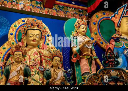 Buddhist temple interior featuring ornate decorations, statues of buddha, and traditional architecture. Serene atmosphere with intricate details, gold Stock Photo