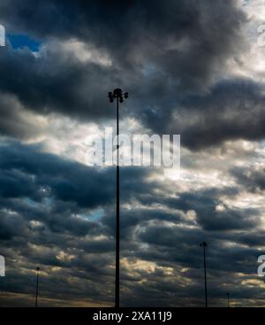 The dramatic dark clouds with lights shining through them Stock Photo