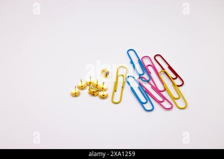 Gold and red paper clips arranged together on a surface Stock Photo