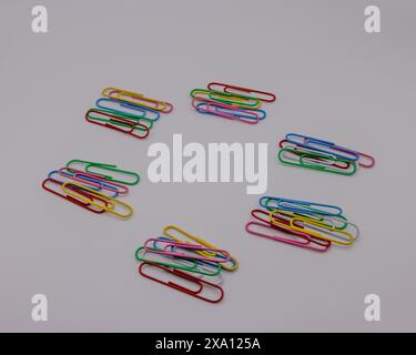 The colorful paper clips arranged in a circular pattern. Stock Photo
