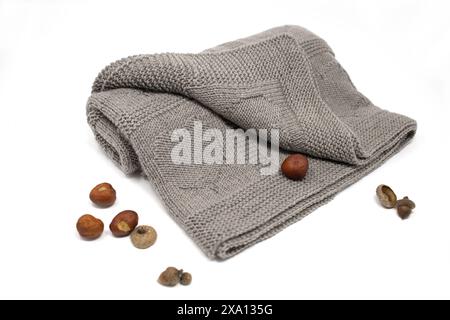 Close-up photography of a brown hand-knitted wool blanket in hearts knitting pattern on a white background Stock Photo