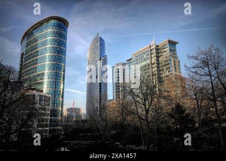 Wide -angle evening shot on a modern futuristic city scape with skyscrapers in the Brussels North business center from Botanical garden Stock Photo