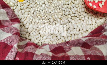 Wooden scoop on beans in checkered towel Stock Photo