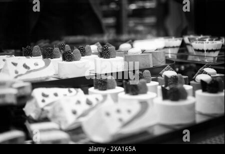 A close-up of various sweets and pastries displayed on shelves in a bakery Stock Photo