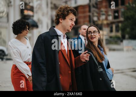 Business colleagues walking and talking outside in a modern urban setting Stock Photo