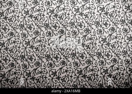 A vintage black and white wallpaper with ornate scrolls in an old-fashioned style Stock Photo