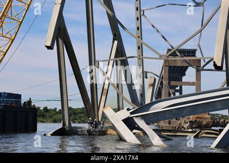 Dundalk, United States of America. 01 June, 2024. Salvage crews use oxyacetylene torches to cut steel trusses as they clear the remaining wreckage of the collapsed Francis Scott Key Bridge over the Patapsco River, June 1, 2024, near Dundalk, Maryland. The Fort McHenry Federal Channel has been reopened to commercial ships as work continues to remove the final 500-plus ton sections of bridge truss.  Credit: Bobby Petty/U.S Army Corps of Engineers/Alamy Live News Stock Photo