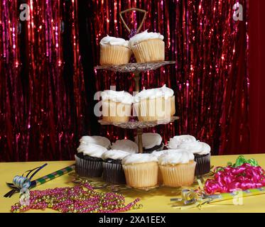 The cupcakes displayed against shiny red ribbons Stock Photo