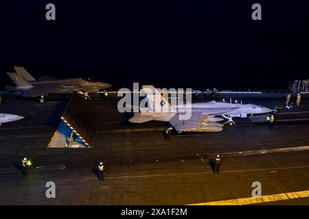 San Diego, United States. 27 May, 2024. A U.S. Navy F/A-18F Super Hornet fighter aircraft, with the Black Aces of Strike Fighter Squadron 41, right, and a Marine Corps F-35C Lightning II, stealth fighter aircraft with the Black Knights of Marine Fighter Attack Squadron 314, left, launch from the flight deck of the Nimitz-class aircraft carrier USS Abraham Lincoln operating on the Pacific Ocean, May 27, 2024 off the coast of California.  Credit: MC2 Michael Cintron/U.S. Navy/Alamy Live News Stock Photo