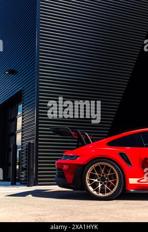 A stunning Guards Red 992 Porsche GT3 RS with Aurum Gold wheels Stock Photo