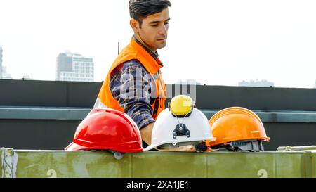 A man wearing a uniform, working at a construction site Stock Photo