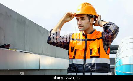 A man in an orange safety vest gesturing to the side. Stock Photo