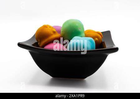 Fondant glazed bonbons filled with a mixture of wallnuts and sugar in a bowl Stock Photo