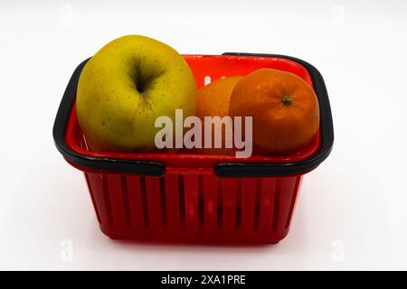 Plastic red basket with fruits on a white background Stock Photo